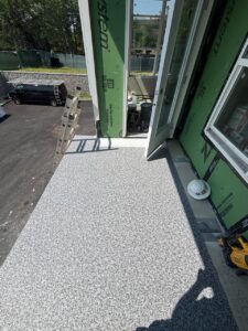 Balcony with textured coating, ladder, construction tool, and helmet