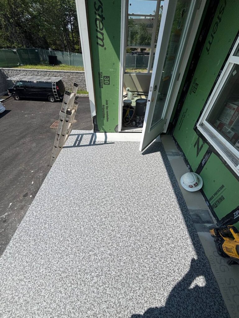 Balcony with textured coating, ladder, construction tool, and helmet