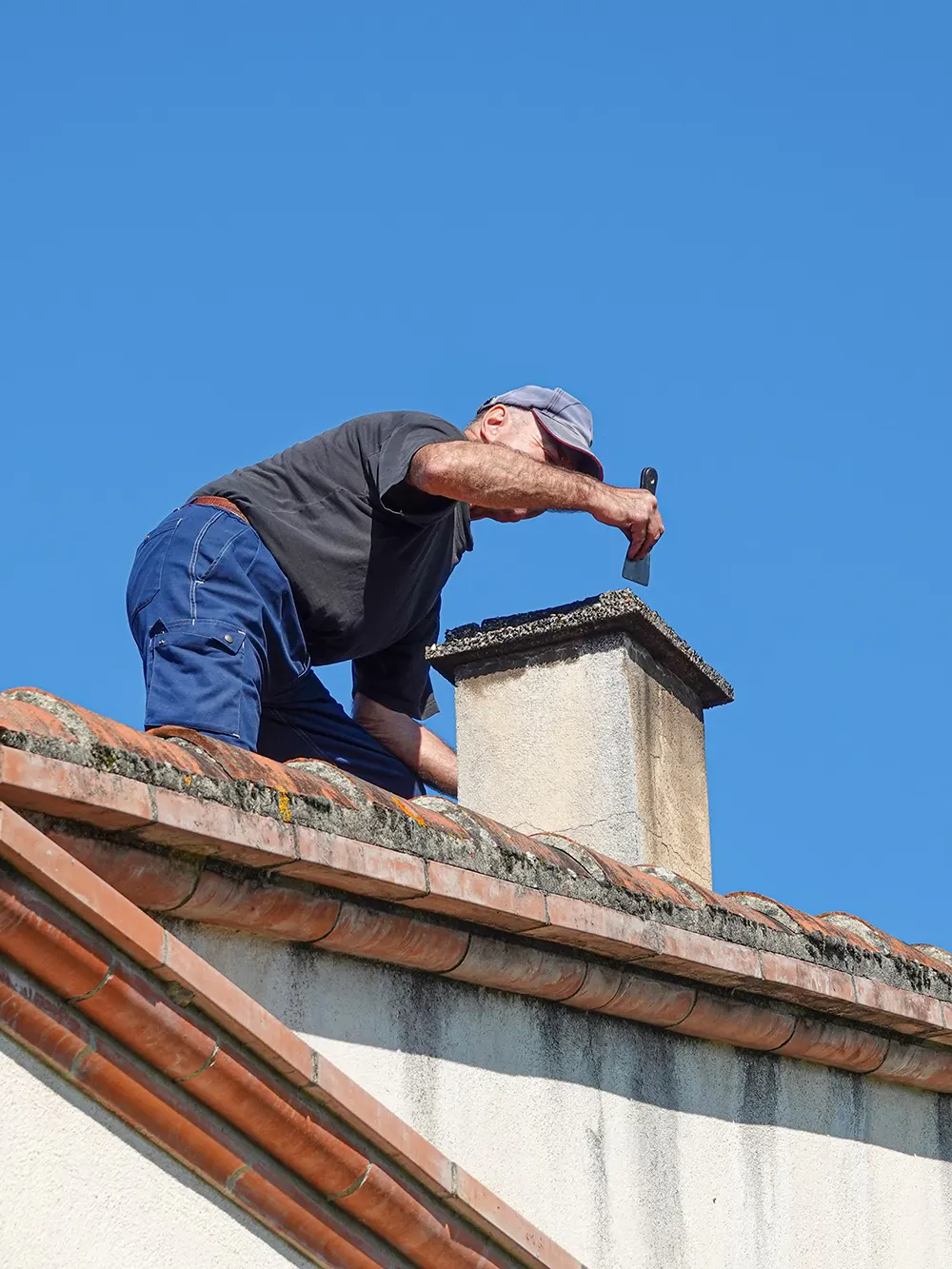A man is repairing a chimney